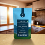 nilgiri black tea pouch from svamingo on a kitchen counter table with kitchen shelves in the background