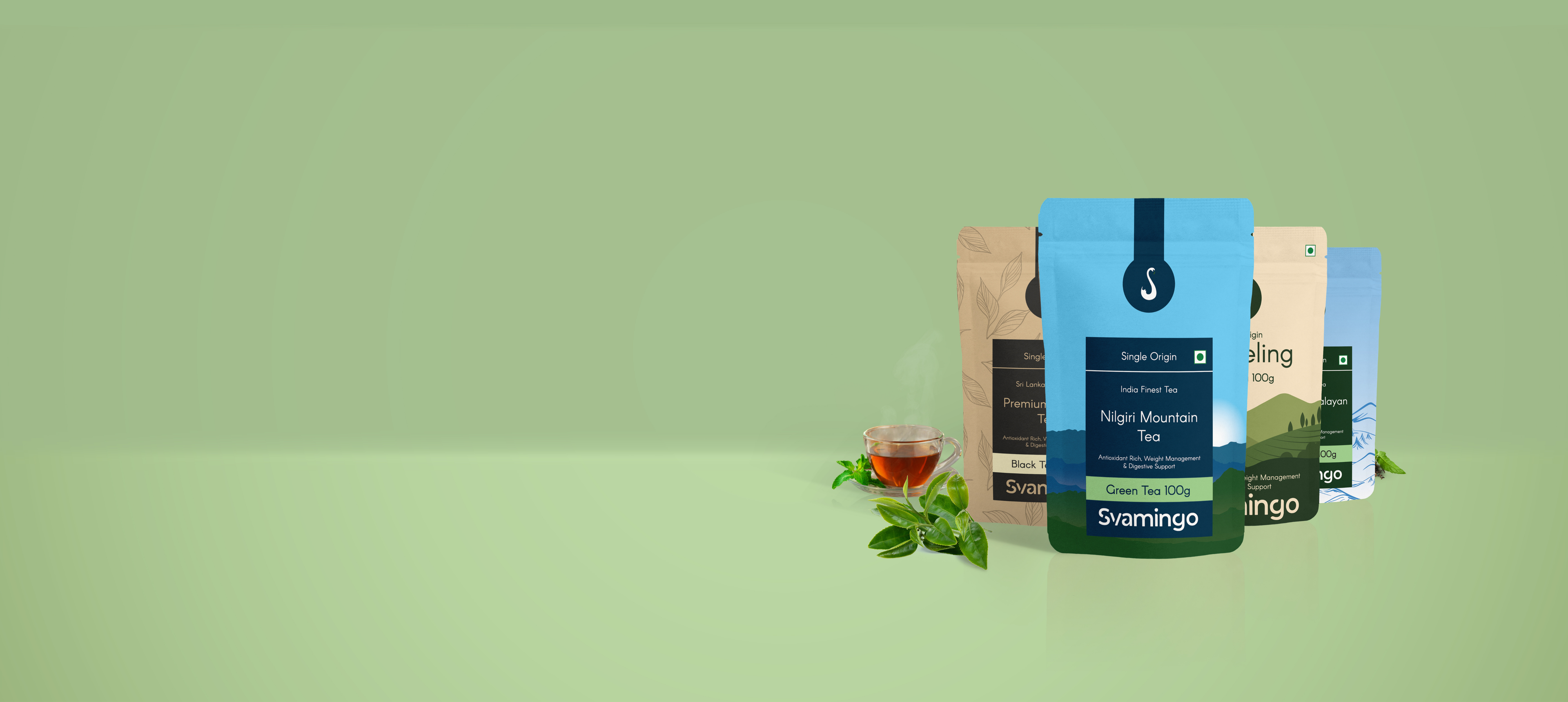Svamingo Tea packages with a cup of tea and mint leaves on a green background
