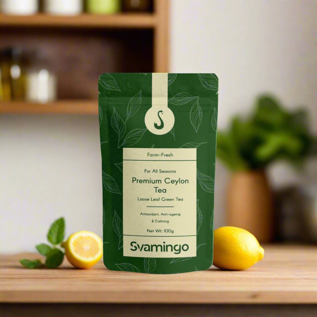 Svamingo Premium Ceylon green Tea package on a wooden surface in kitchen with lemons on side